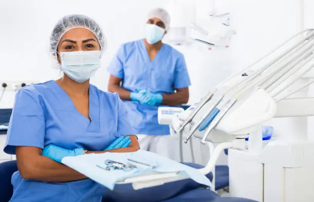 Two dental surgeons masked up