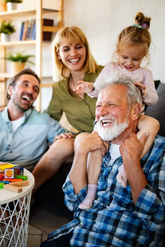 Mature grandparents playing with grandchildren and having fun with family